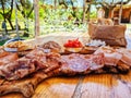 View of the platter of Italian cured meats and bruschetta on an outdoor farmhouse on a wooden table