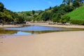 View on Playa de Poo during low tide near Llanes, Green coast of Asturias, North Spain with sandy beaches, cliffs, hidden caves,