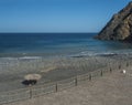 View of Playa de Vallehermoso, volcanic black sand beach with pebbles and sun umbrellas beautiful bay with blue ocean Royalty Free Stock Photo