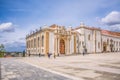 View of plaza of University of Coimbra, with tourists and building of the Joanina Library, in Coimbra, Portugal Royalty Free Stock Photo