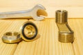 View plumbing tools brass pipe connectors on wooden board close up