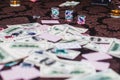 View of poker table with pack of cards, tokens, alcohol drinks, dollar money and group of gambling rich wealthy people playing Royalty Free Stock Photo