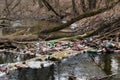 View of the polluted small forest river with a lot of different plastic garbage. Environment pollution problem Royalty Free Stock Photo