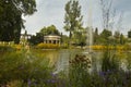 View of the pond with a fountain in the garden \