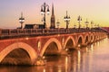 Pont de Pierre bridge with St Michel churh in Bordeaux