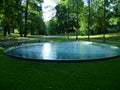 View of pool with water,  canadian geese, grass, trees  in Helsinki, Finland Royalty Free Stock Photo