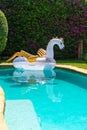 Giant inflatable Pegasus in the pool with clear azur water Royalty Free Stock Photo