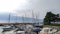 view of the port of Bogliaco on Lake Garda in Brescia in Italy with sailboat and motorboat. important tourist centre