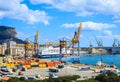 View of port with cranes, containers and city of Palermo in Sicily