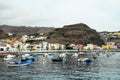 View of the port full of colorful boats and a city in the Canary island of Spain Royalty Free Stock Photo