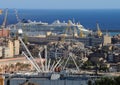 View of the port of Genoa with the Ferris wheel and a cruise ship in the background, seen from the top of the D`Albertis castle.