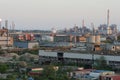 View on Port Marghera industrial part of Venice from container terminal during sunset. In fore are old buildings.