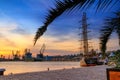 View of the port of Varna at sunset, sailing ships and harbor cranes in the background