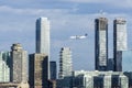 Porter airlines plane flying over Toronto downtown skyline, Toronto, Canada