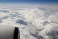 View from the porthole of the airplane to the blue sky with white clouds Royalty Free Stock Photo