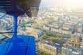 View in the porthole airplane of a turboprop aircraft biplane on the city streets and houses.