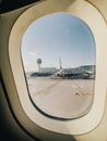 Afines, Greece - 20 august 2023: View from the porthole on a passenger plane standing in front of the airport building