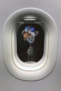 View from porthole window on astronaut with planets shaped balloons in solar system. Elements of this image furnished by NASA Royalty Free Stock Photo