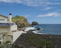 View of Porto da Cruz village with black stone beach and sea water swimming pool. Madeira Island, Portugal Royalty Free Stock Photo