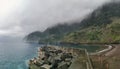 View at the Porto do Seixal beach and coast with fog, on Seixal village, formed by volcanic rocks, coast of the Madeira island, Royalty Free Stock Photo