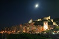 View of Portovenere`s buildings at night under the moon with a castle, tower and cathedral illuminated Royalty Free Stock Photo