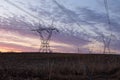 View of power line towers in farmland fields during a beautiful spring sunrise, St.-Pierre, Island of Orleans Royalty Free Stock Photo