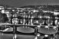 View on the Prague cityscape together with the bridges crossing the vltava river passing through the city, all in black and white Royalty Free Stock Photo