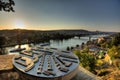 View on Prague cityscape and Vltava river in late afternoon sun with an old metallic map of Prague landmarks sculpture