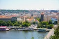 View of Prague with Vltava with ships and amazing buildings with red roofs.