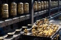 Prayer wheels and butter lamps in the courtyard of Kwa Bahal or Golden Temple Patan Nepal