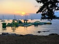 A view of a pretty water playground floating on the ocean during sundown surrounded by boats outside of Rovinj, Croatia.