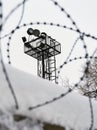 View on prison guarding tower through barbed wire Royalty Free Stock Photo