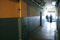 View of prison hallway, doors to cells, prison guards standing at the far end of it. Lukyanivska detention facility Royalty Free Stock Photo