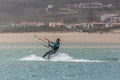 View of a professional sportswoman practicing extreme sports Kiteboarding at the Obidos lagoon