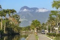 Promenade with trees of river Pereque-Acu and mountains, Paraty, Brazil Royalty Free Stock Photo