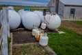 View of propane tanks outside of amish family home used as alternative power source to electricity in a farmland in