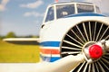 View on propeller on old russian airplane on green grass