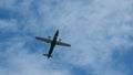 View of propeller plane flying low with blue sky and clouds at background Royalty Free Stock Photo