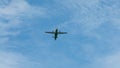 View of propeller plane flying low with blue sky and clouds at background Royalty Free Stock Photo