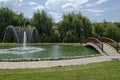 View of public garden with beauty artificial pond, fountain and bridge, town Delchevo among Maleshevo and Osogovo mountains Royalty Free Stock Photo