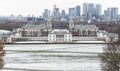 View of Queens House and Canary Wharf from Greenwich Park in winter snow Royalty Free Stock Photo