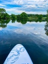 A view of the quiet surface of the lake from a sup board. Royalty Free Stock Photo