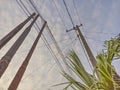 View of a quiet village with blue sky and power lines overhead.