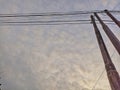 View of a quiet village with blue sky and power lines overhead.