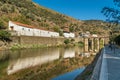 View on Quinta do Sagrado and old stone bridge over Duoro river in Pinhao v