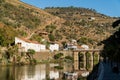 View on Quinta do Sagrado and old stone bridge over Duoro river in Pinhao village, Portugal