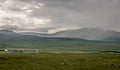 A view of Quirang hiils in the distance from the walking path from Staffin village to Staffin harbour and An Corran Beach Royalty Free Stock Photo