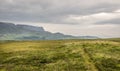 A view of Quirang hiils in the distance from the walking path from Staffin village to Staffin harbour and An Corran Beach Royalty Free Stock Photo