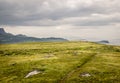 A view of Quirang hiils in the distance from the walking path from Staffin village to Staffin harbour and An Corran Beach Royalty Free Stock Photo