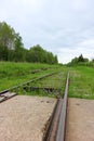 View from railroad crossing to abandoned rail track overgrown with grass in Russia Royalty Free Stock Photo